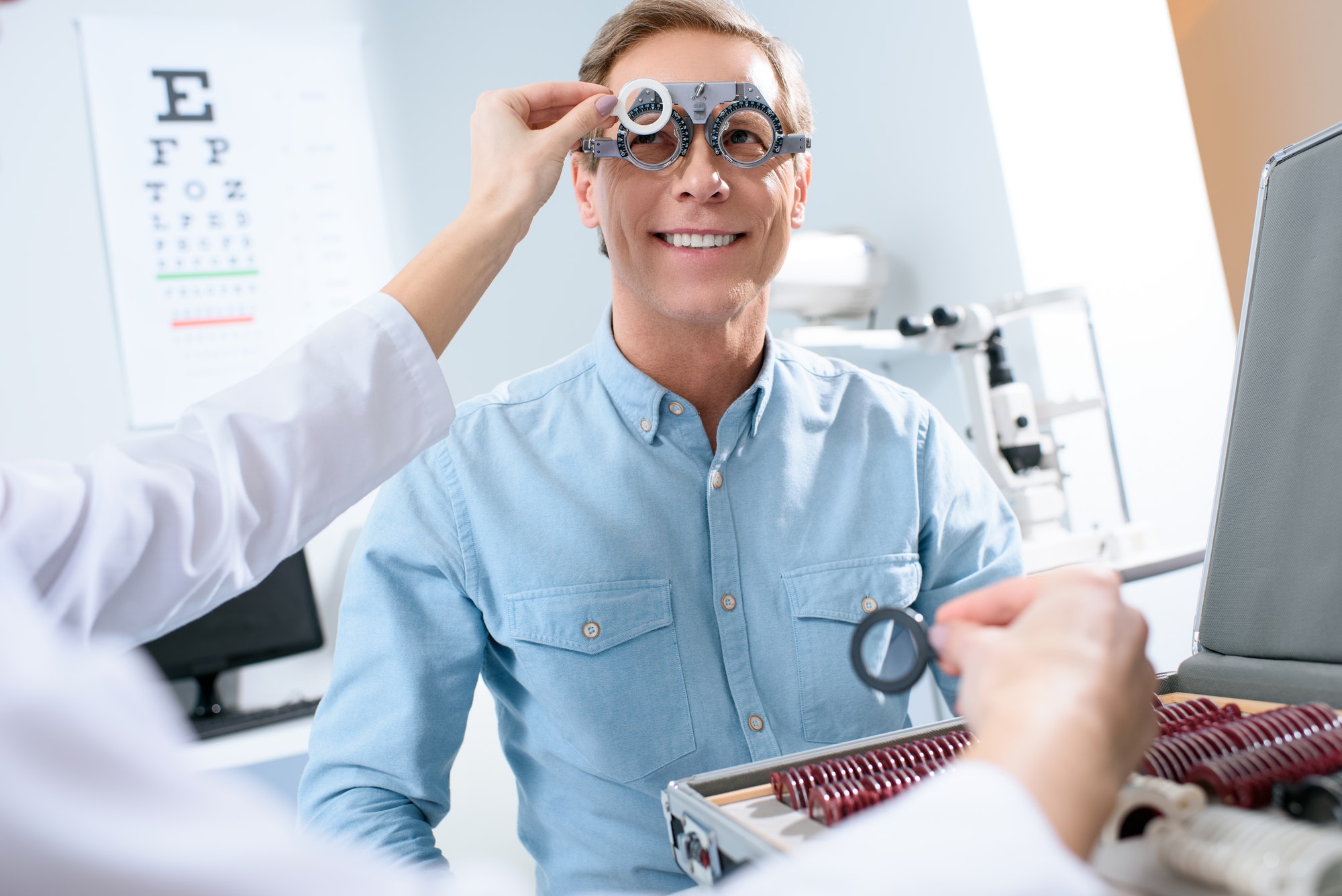 ophthalmologist-examining-middle-aged-man-eyes-with-trial-frame-and-lenses.jpg